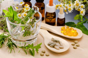 A table with some herbs and pills on it