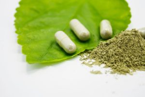 A green leaf with some pills on it